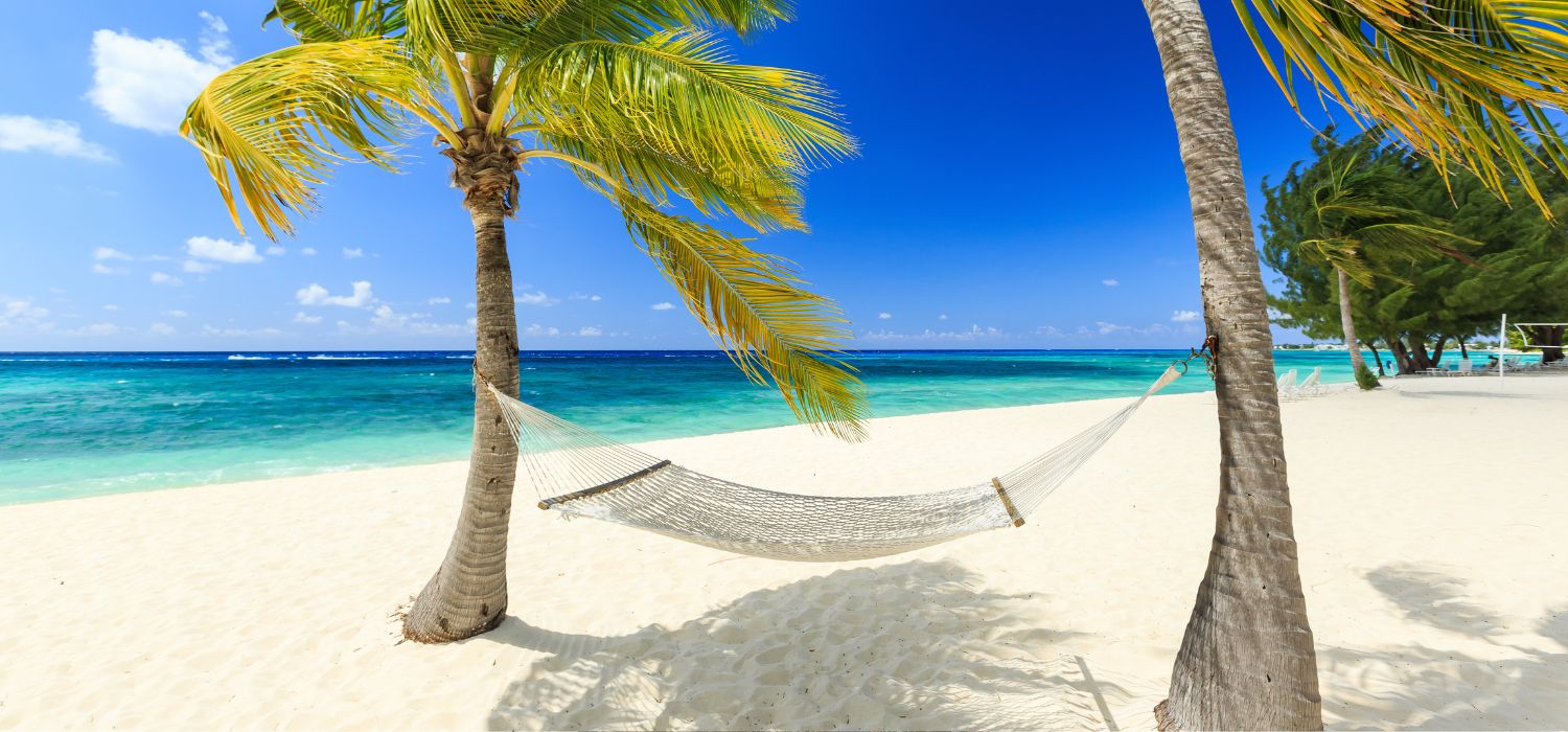 Hammock and palm trees at 7 mile beach, Grand Cayman