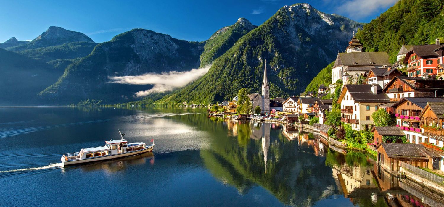 Image of famous alpine village Halstatt during colourful fall morning.