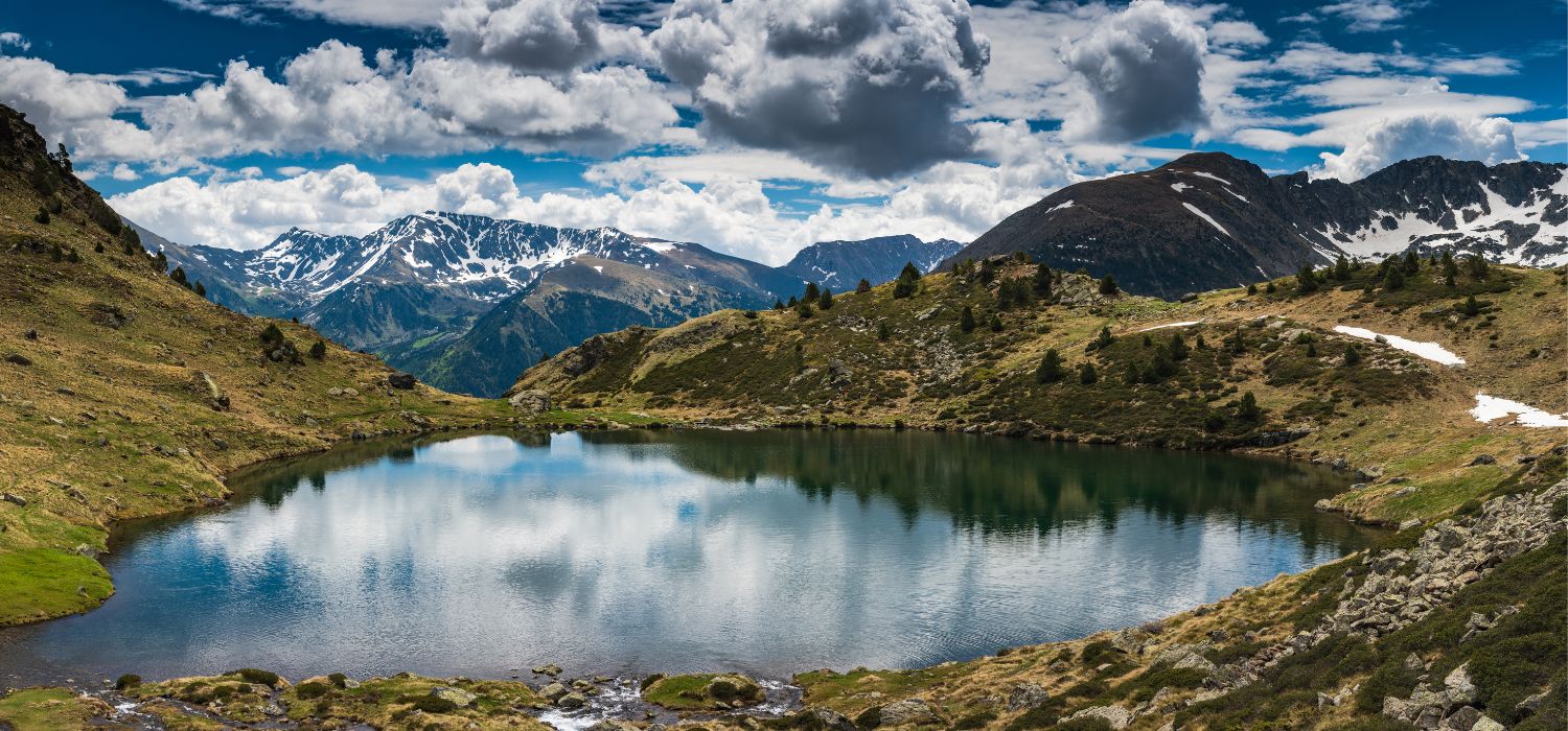 Wide panoramic vista over Tristaina lake, Andorra