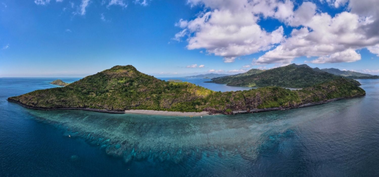 Drone view of white sand beach of Mayotte turquoise lagoon